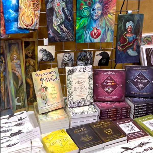 LTZ's booth at 2024 Paganicon filled with books on Sigil Witchery and witchcraft as well as art, decks, and stickers
